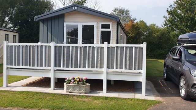Front view of Swift Static Caravan with white fence
